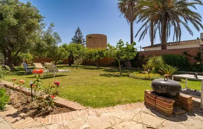a garden with a fountain in the middle of a yard at Stunning Home In Conil De La Frontera in Conil de la Frontera