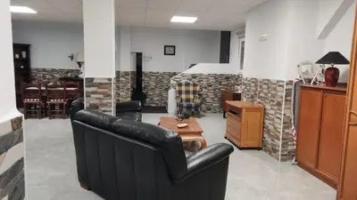 a living room with black leather chairs and a table at Loft los olivos in Algar