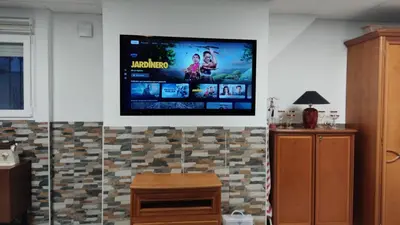 a flat screen tv hanging on a wall at Loft los olivos in Algar
