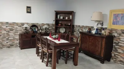 a kitchen with a wooden table and chairs at Loft los olivos in Algar