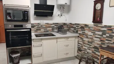 a kitchen with a microwave and a stove top oven at Loft los olivos in Algar