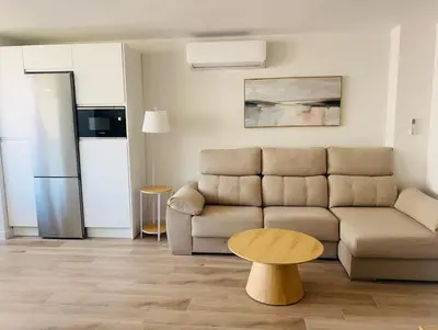 a living room with a couch and a table at Mi casa vacacional en Valdelagrana in El Puerto de Santa María