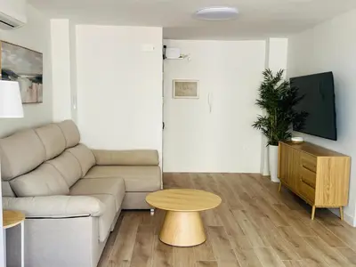 a living room with a couch and a table at Mi casa vacacional en Valdelagrana in El Puerto de Santa María