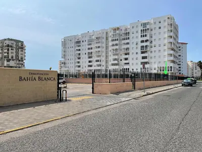 an empty street in front of a large building at Mi casa vacacional en Valdelagrana in El Puerto de Santa María