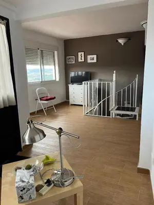 a living room with a desk with a lamp on a table at Casa Patricia I in Arcos de la Frontera
