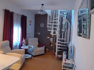 a living room with a spiral staircase in a room at Casa Patricia I in Arcos de la Frontera