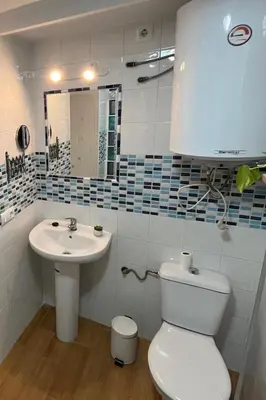 a bathroom with a white toilet and a sink at Casa Patricia II in Arcos de la Frontera