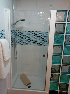 a bathroom with a shower with a glass door at Casa Patricia II in Arcos de la Frontera
