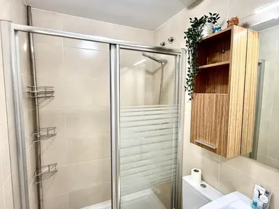 a bathroom with a shower and a toilet at Mi sueño free parking by staycare in Rota