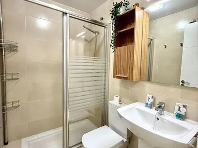 a bathroom with a shower and a toilet and a sink at Mi sueño free parking by staycare in Rota
