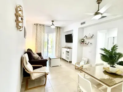 a living room with a glass table and a couch at Mi sueño free parking by staycare in Rota