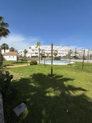 a shadow of a tree in a park with a pool at Mi sueño free parking by staycare in Rota