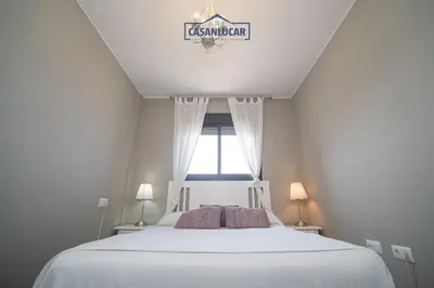 a bedroom with a white bed and a window at Atico Molinillo in Sanlúcar de Barrameda