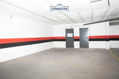 an empty parking garage with a sign on the wall at Atico Molinillo in Sanlúcar de Barrameda