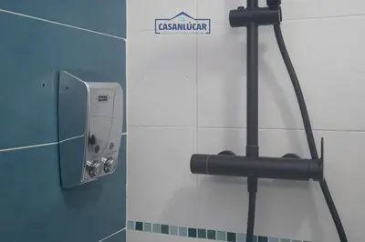 a bathroom with a soap dispenser on the wall at Atico Molinillo in Sanlúcar de Barrameda