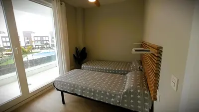 a room with two beds and a large window at Ocean Home - Costa Ballena in Costa Ballena
