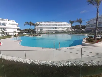 a large swimming pool in front of a building at Ocean Home - Costa Ballena in Costa Ballena