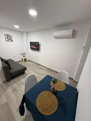 a living room with a blue table and chairs at Apartamento Bf Jerez in Jerez de la Frontera