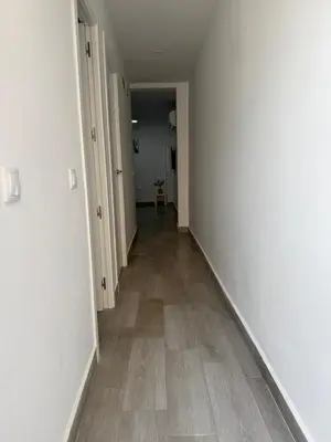 an empty hallway with white walls and wooden floors at Apartamento Bf Jerez in Jerez de la Frontera