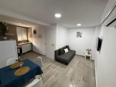 a small living room with a table and a couch at Apartamento Bf Jerez in Jerez de la Frontera