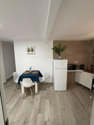 a kitchen and dining room with a table and chairs at Apartamento Bf Jerez in Jerez de la Frontera