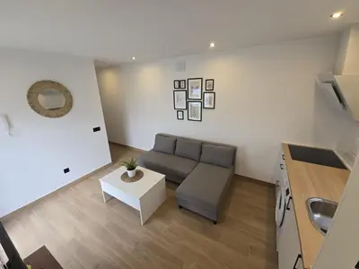 a living room with a couch and a table at Chiclanafactory in Chiclana de la Frontera