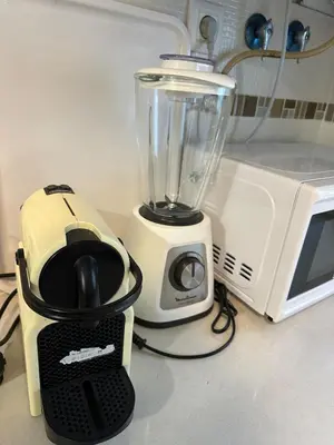 a blender sitting next to a toaster and a microwave at El Ancla in Novo Sancti Petri