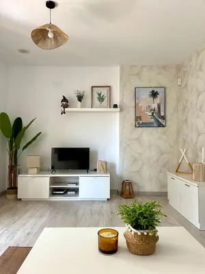 a living room with a tv and a couch at El Ancla in Novo Sancti Petri