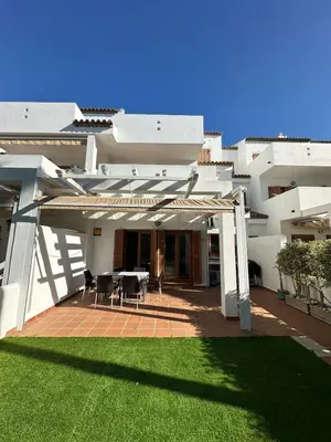 a large white house with a patio and a lawn at El Ancla in Novo Sancti Petri