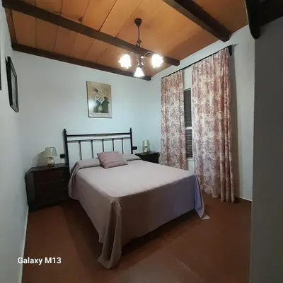 a bedroom with a bed and a window at la petit in Chiclana de la Frontera