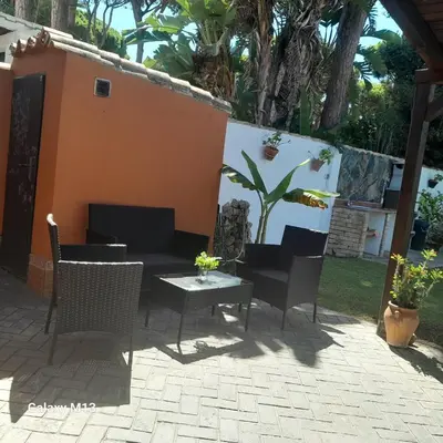 a patio with a table and chairs on a patio at la petit in Chiclana de la Frontera