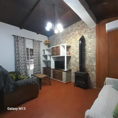 a living room with a couch and a fireplace at la petit in Chiclana de la Frontera