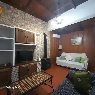 a living room with a bed and a tv at la petit in Chiclana de la Frontera