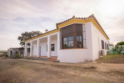a white house with a yellow roof at Casa Rural Manuel Sevillano in Bornos