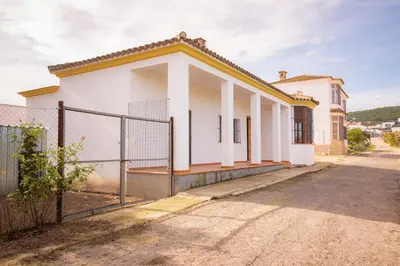 a white house with a fence in front of it at Casa Rural Manuel Sevillano in Bornos