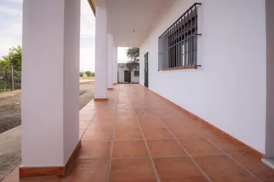 an empty hallway of a house with a tile floor at Casa Rural Manuel Sevillano in Bornos