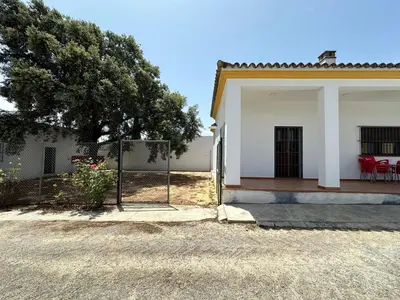 a white house with a fence in front of it at Casa Rural Manuel Sevillano in Bornos