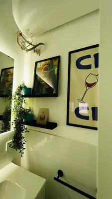 a bathroom with a sink and some pictures on the wall at Precioso Apartamento Centro Jerez in Jerez de la Frontera