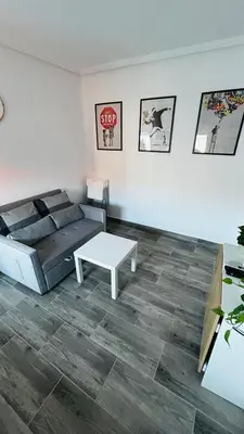 a living room with a bed and a coffee table at Precioso Apartamento Centro Jerez in Jerez de la Frontera