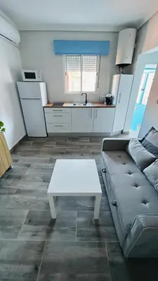 a living room with a couch and a table at Precioso Apartamento Centro Jerez in Jerez de la Frontera