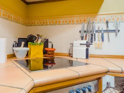 a kitchen with a counter with a stove top oven at Villa La Vega 14354 in Chiclana de la Frontera