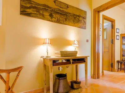 a room with a table and a lamp on a wall at Villa La Vega 14354 in Chiclana de la Frontera