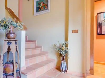 a staircase with two vases and flowers in a room at Villa La Vega 14354 in Chiclana de la Frontera