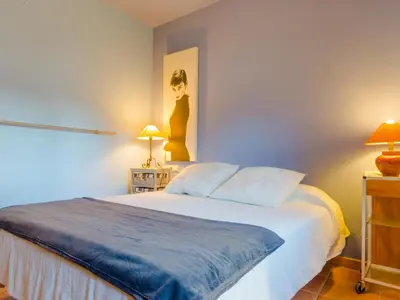 a bedroom with a bed and a painting on the wall at Villa La Vega 14354 in Chiclana de la Frontera