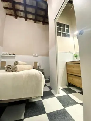 a bedroom with a bed and a checkered floor at Apartamento Moraito Chico in Jerez de la Frontera