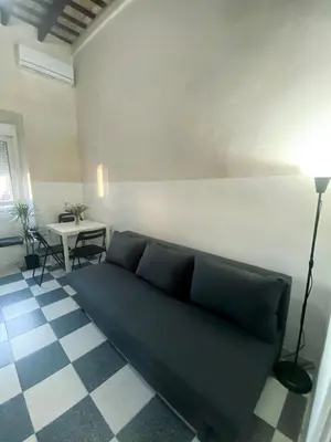 a living room with a couch and a table at Apartamento Moraito Chico in Jerez de la Frontera