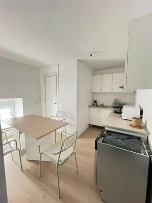 a kitchen with a table and a table and chairs at Centrally located apartment with terrace in El Puerto de Santa María