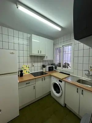 a kitchen with a washing machine and a sink at Frente al Mar, Tu Refugio Ideal in Novo Sancti Petri