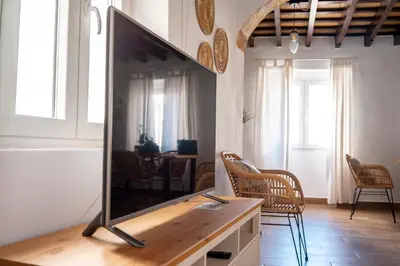 a living room with a flat screen tv on a table at Casa Cuesta Belén in Arcos de la Frontera