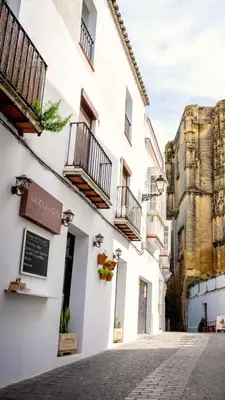 a street in a city with a white building at Casa Cuesta Belén in Arcos de la Frontera